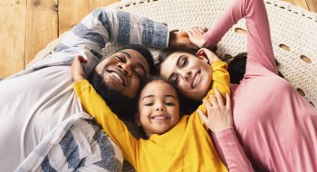 family-evening-multiracial-family-daughter-hugging-GHEWGPU.jpg